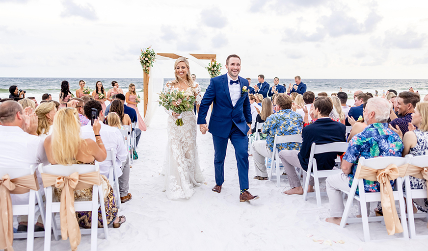 walking down aisle on beach